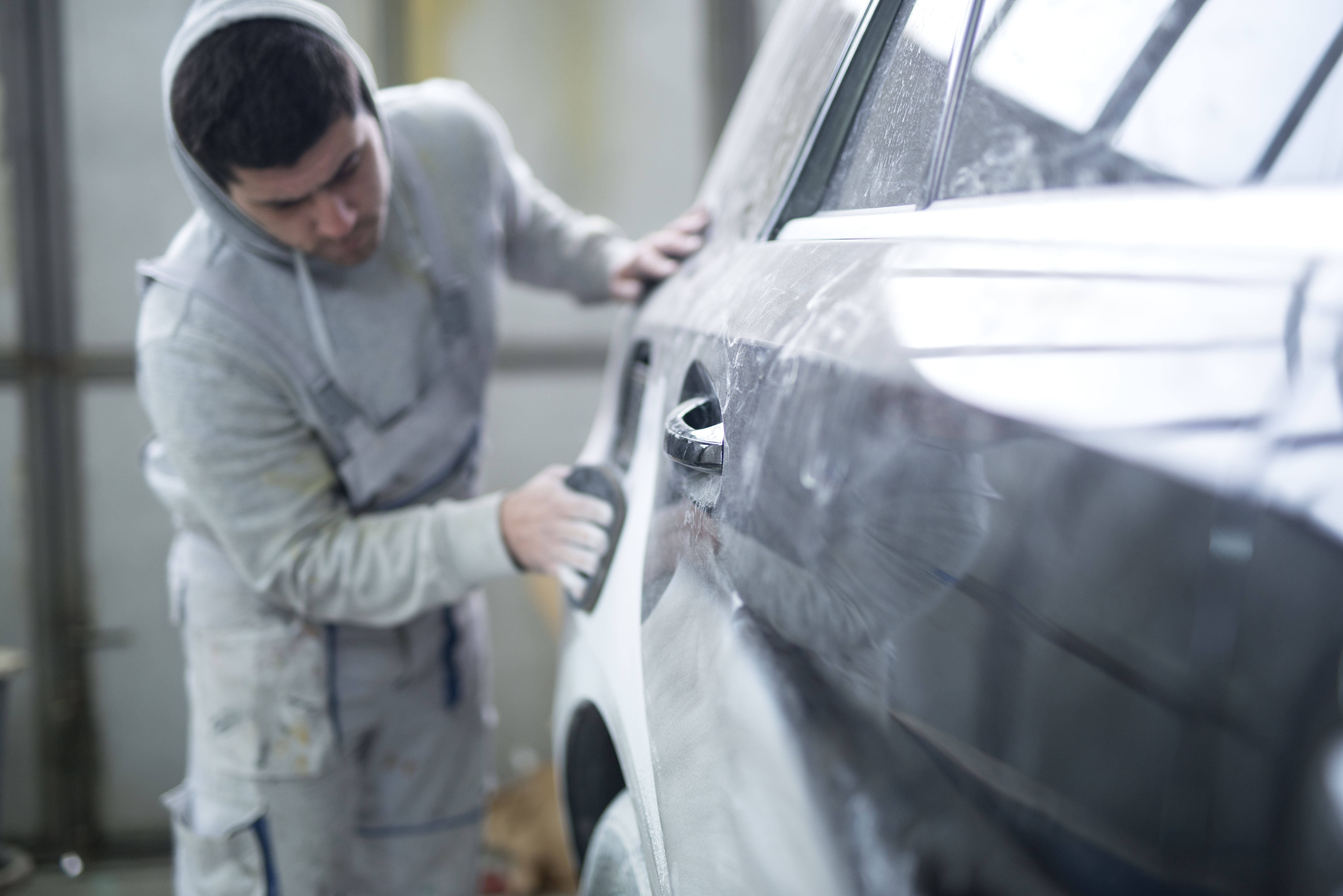 repairman preparing car painting workshop